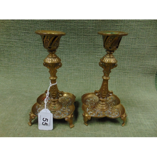 55 - Pair of brass candle sticks.