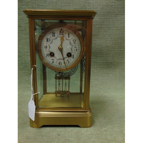 98 - Large 19th century brass carriage clock, having floral enamel face with Arabic numerals. 10 x 6 x 5