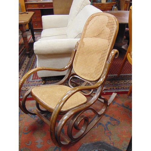 312 - Reproduction Bentwood rocking chair, having cane back and seat.