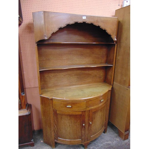 327 - An oak dresser, plate rack back over bowfront centre with pair of drawers and cupboard doors. 66 x 4... 