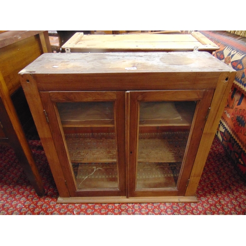 319 - Pine glazed two door cabinet, and a pine bookcase (2).