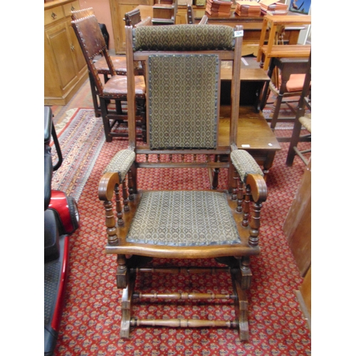 324 - Beech framed rocking chair, upholstered back , arms and seat.