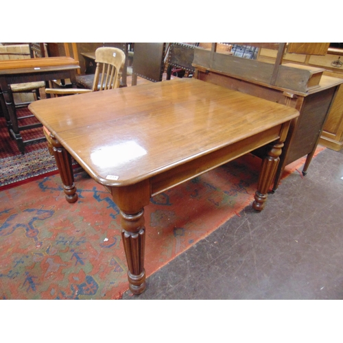 331 - Antique mahogany extending dining table, rounded corners, with two extra leaves , and on reeded turn... 