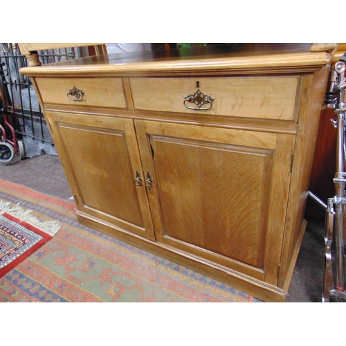 353 - Golden oak sideboard, pair of short drawers with gilt metal handles, two cupboard doors