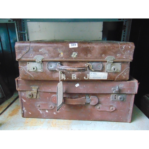 389 - Two vintage leather suitcases, having original travel labels.