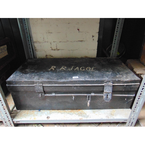 390 - Large tin travel trunk, having lift up lid and side handles.