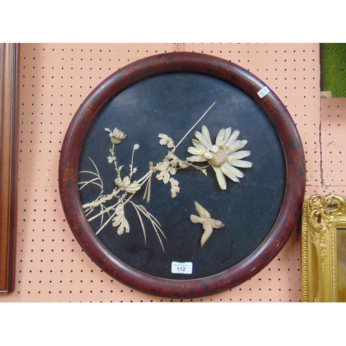 112 - Circular Oriental relief wall plaque, Bird and flowering branches, within a lacquered frame. 18