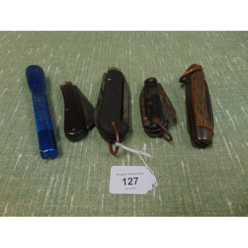 127 - Four pocket knives and a small torch. (5).