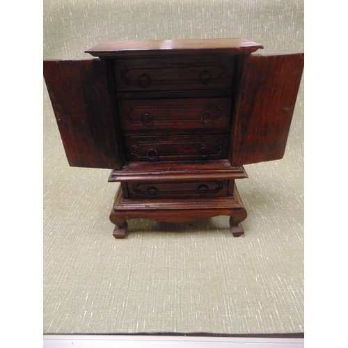 54 - Hardwood table top cabinet, ogive cornice, pair of doors, enclosing a set of three drawers , with fu... 