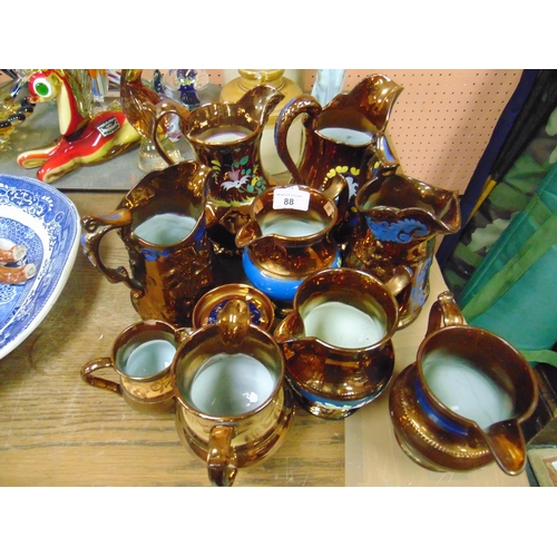 88 - Collection of antique copper lustre jugs.