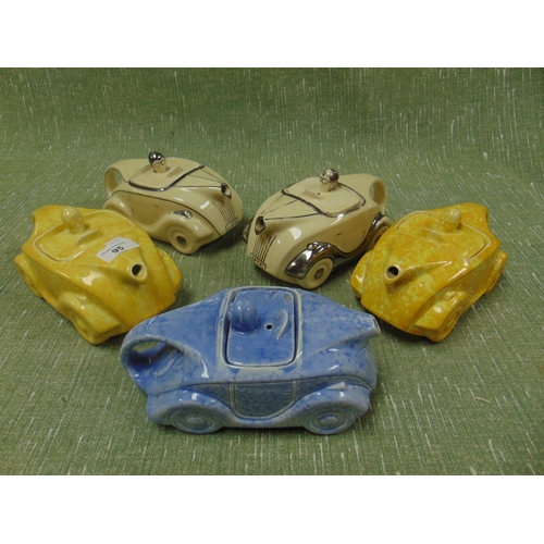 95 - Five art deco racing car form tea pots.