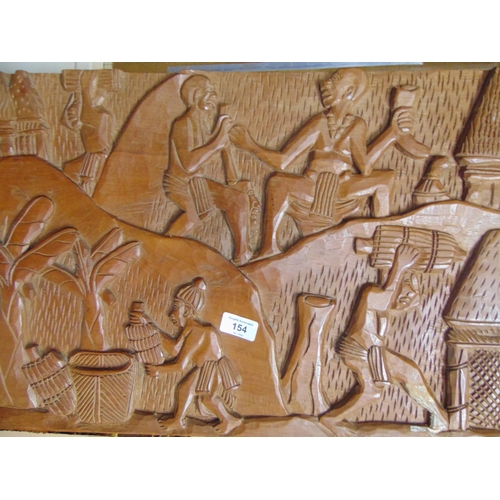 154 - African carved wooden panel , decorated with traditional figures. 71 x 15