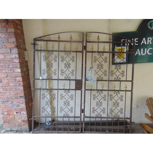 349 - Good pair of cast metal gates, arched tops, shaped decoration with posts and attachments. The gates ... 