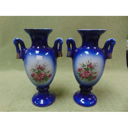 140 - Pair of floral decorated two handled vases.