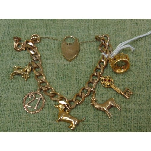 21 - 9ct gold charm bracelet, having 7 9ct gold charms and heart shaped padlock, 48 grm.