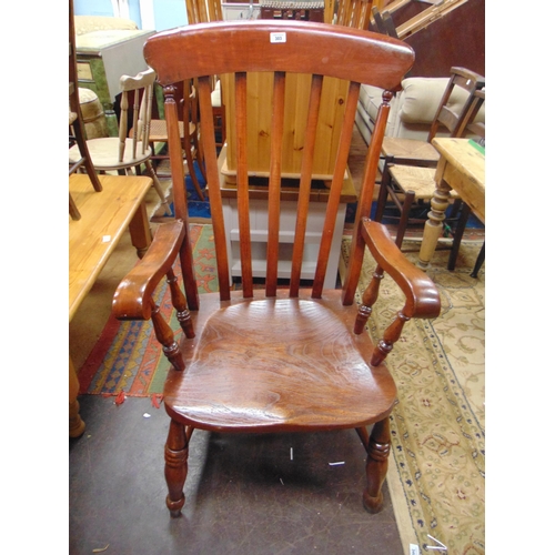 303 - An elm farm house chair, rail back, open arms, solid seat, on turned supports and stretchers.