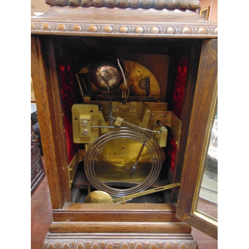 33 - An oak cased bracket clock, having moulded decoration, gilt highlights, three train movement strikin... 