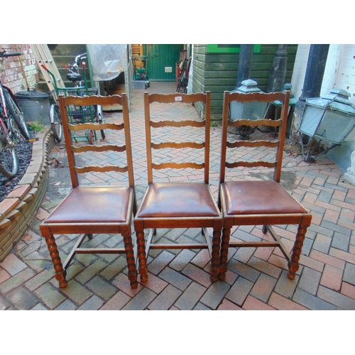 397 - Set of three oak ribbon back chairs, having drop in seats and on frontal bobbin supports.