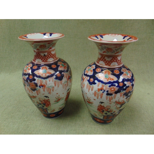 65 - Pair of antique Imari pattern vases, having traditional decoration, each 11.5