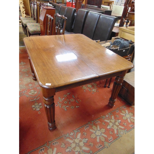 512 - Antique mahogany extending dining table, rounded corners, with two extra leaves , and on reeded turn... 