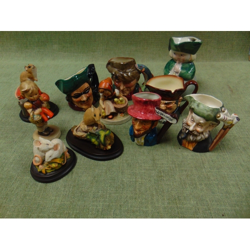 106 - Two Doulton miniature character jugs, three country artists resin figure groups, two Hummel figures,... 