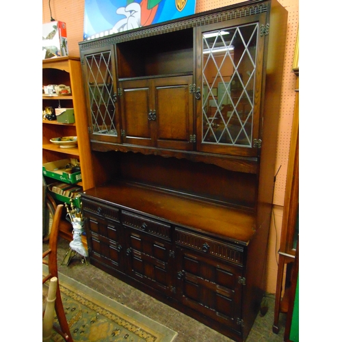 491 - An oak dining suite, comprising drop leaf table, four chairs and matching lounge unit.