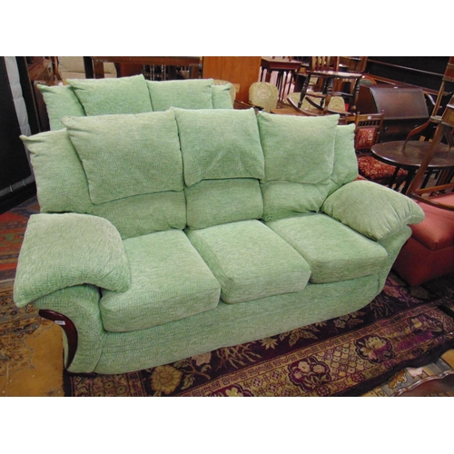 Green upholstered lounge suite comprising three and two seater settees 