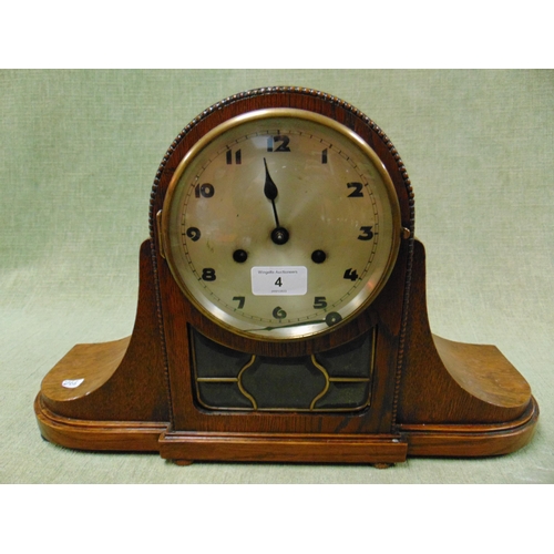 4 - An oak cased mantle clock, having silvered face and Arabic numerals.