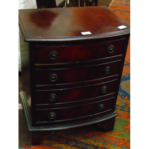 303 - Reproduction mahogany bow fronted dwarf chest, having four long drawers with ring handles and on bra... 