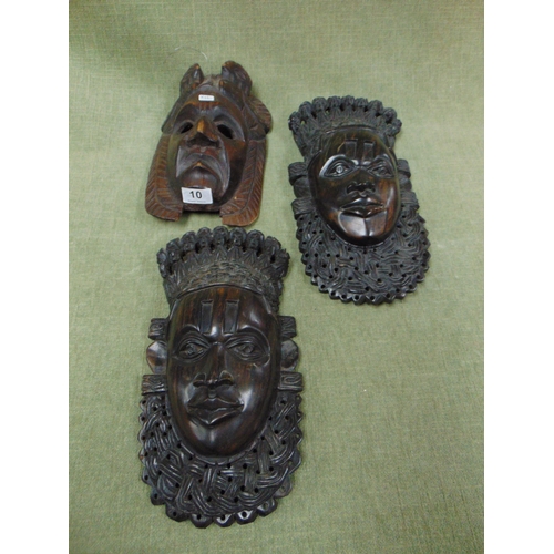 10 - Three reproduction African ebony wall masks.