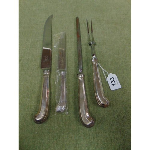 133 - Three piece pistol handled carving set and a similar table knife.