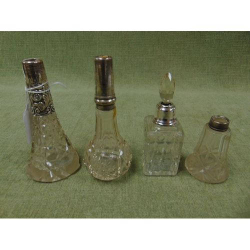 153 - Two silver mounted scent bottles and two possibly silver mounted examples. (4).