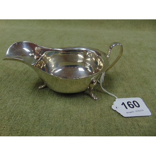 160 - Silver sauce boat, having scroll handle and on pad feet, Sheffield, 1933. 3.3 ozt.