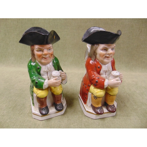 173 - Pair of antique Staffordshire Toby jugs, modelled as seated gentlemen holding foaming jugs of ale. E... 