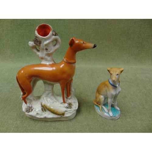 181 - 19th century Staffordshire Greyhound spill vase, together with another figure modelled as a seated g... 