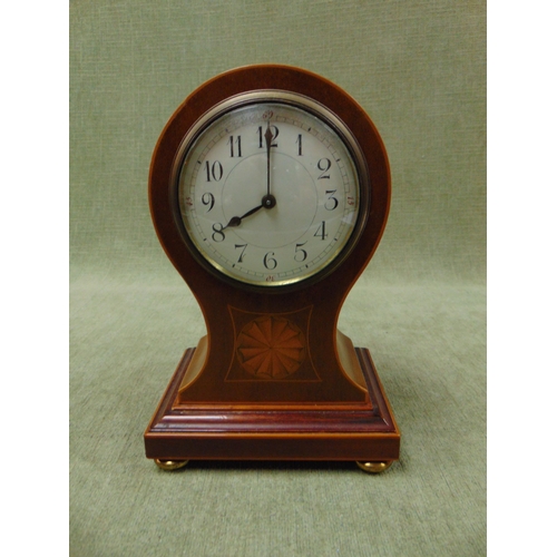 187 - Antique inlaid mahogany balloon form mantle clock , having arabic numerals and on bun feet. 9