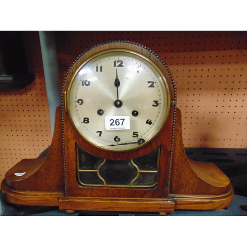 267 - An oak cased mantle clock, having silvered face and Arabic numerals.