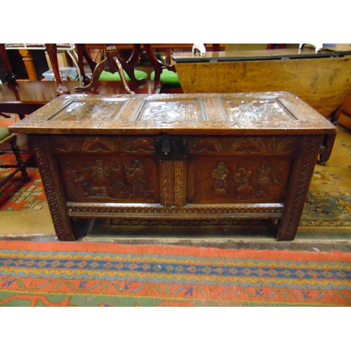 302 - Antique oak coffer, having all over carved decoration, lift up triple panel lid, further panels to f... 