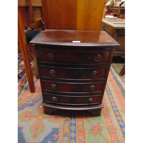 303 - Reproduction mahogany bow fronted dwarf chest, having four long drawers with ring handles and on bra... 