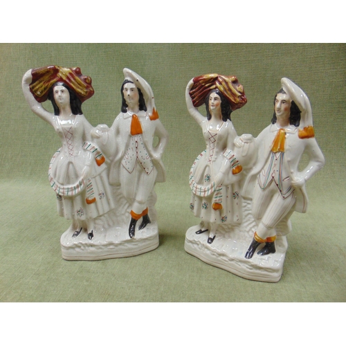 48 - Pair of 19th century Staffordshire figure groups, each modelled as a Highland man and woman. 13