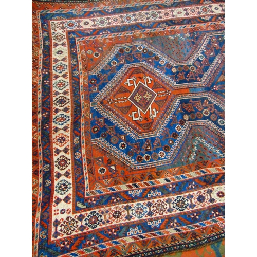 5 - Good Persian blue and red ground rug having geometric pattern. 117 x 83