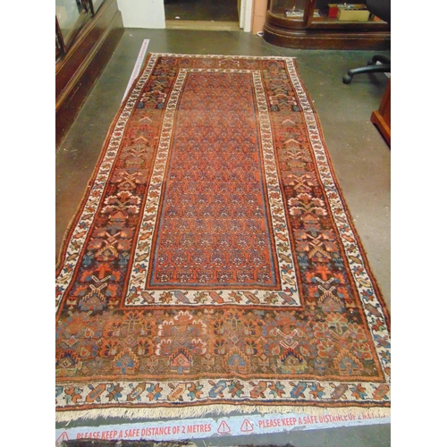 60 - Good Persian red and blue ground rug,  having geometric pattern. 105 x 49