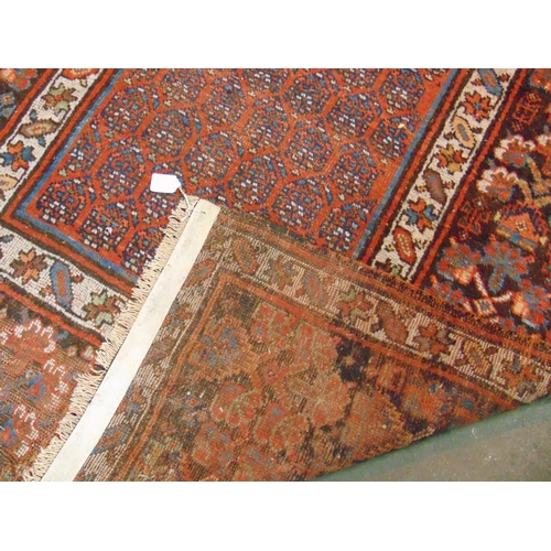 60 - Good Persian red and blue ground rug,  having geometric pattern. 105 x 49