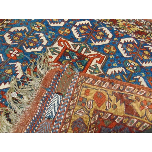 62 - Small Persian red, yellow and blue ground rug. 28 x 30