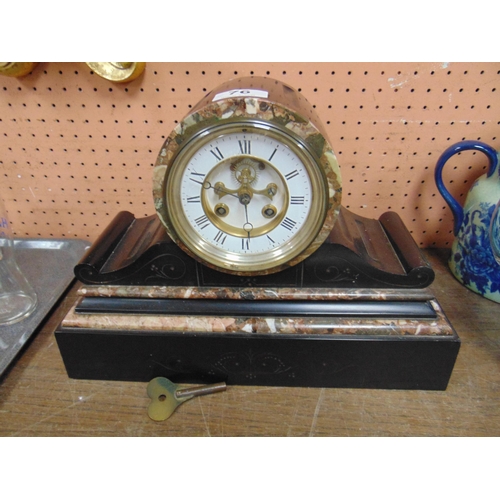 76 - Antique black marble drum head mantle clock, having enamel face and Roman numerals. 10 x 14 x 6