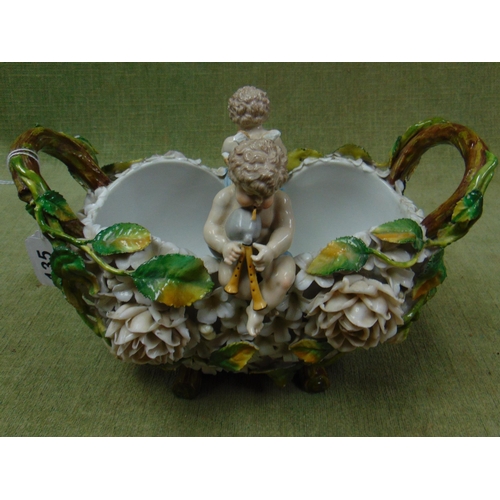 135 - Ornate continental two handled bowl, decorated with figural cherubs. 8 x 11