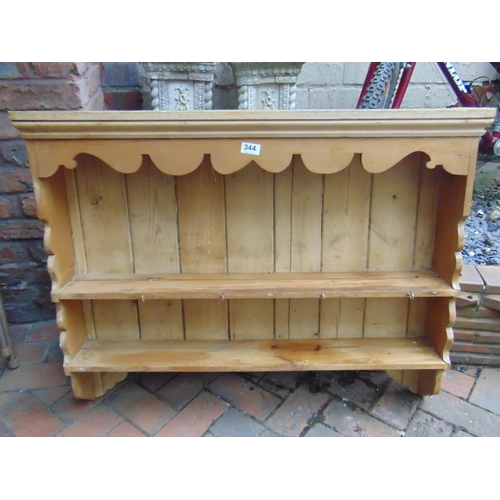 344 - Pine wall rack, ogive cornice above two shelves. 30 x 38 x 6.5