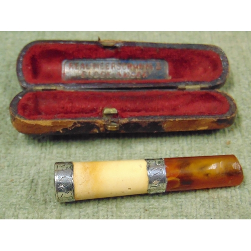 354 - Meersham and amber bodied cigarette holder, having possibly silver banding.