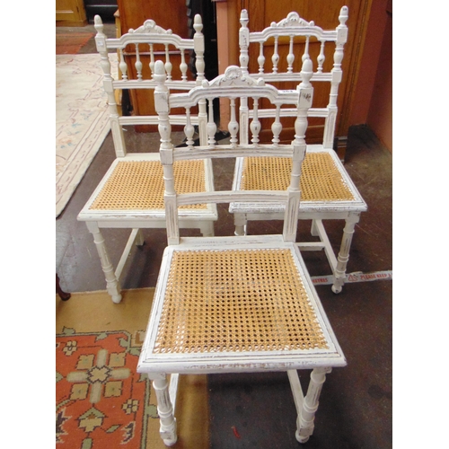 363 - Set of three painted continental spindle back cane seated chairs.