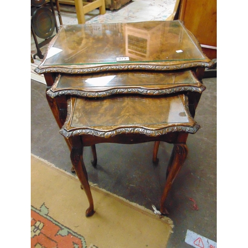 373 - Glass topped walnut veneered nest of three tables, set on cabriole supports, together with a folding... 